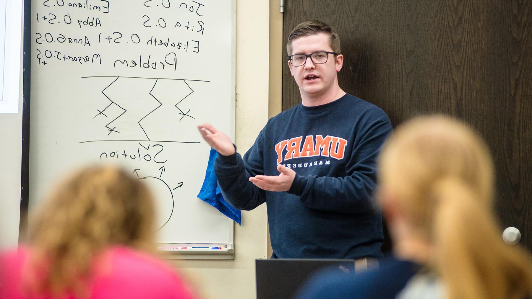 A Math Teaching working through a problem with students in class.